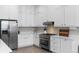 Stylish kitchen featuring white cabinetry, stainless steel appliances, and decorative backsplash at 12214 Stone Timber Ct, Parker, CO 80134