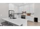 Modern kitchen with white cabinets, stainless steel appliances, and a center island with seating at 12214 Stone Timber Ct, Parker, CO 80134