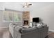 Inviting living room with a stone fireplace and a large, comfortable gray sectional sofa at 12214 Stone Timber Ct, Parker, CO 80134