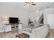 Inviting living room featuring a comfortable sectional sofa and staircase at 12214 Stone Timber Ct, Parker, CO 80134