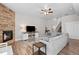 Inviting living room with brick fireplace, television, hardwood floors, and comfortable seating at 12214 Stone Timber Ct, Parker, CO 80134