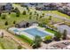 Community pool area showcasing a large pool, sunbathing area, picnic shelter, mature trees, and secure fencing for safety at 12214 Stone Timber Ct, Parker, CO 80134