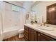 Traditional bathroom with a combined tub and shower, single sink, and ample storage at 10050 Eagle Valley Way, Highlands Ranch, CO 80129