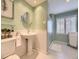 Stylish bathroom with pedestal sink, tiled floors, and walk-in shower at 10050 Eagle Valley Way, Highlands Ranch, CO 80129