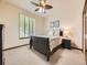 Comfortable bedroom with a window, dark wood furniture, and neutral tones at 10050 Eagle Valley Way, Highlands Ranch, CO 80129