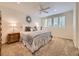 Well-lit bedroom with ceiling fan, plantation shutters, and neutral decor at 10050 Eagle Valley Way, Highlands Ranch, CO 80129