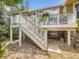 Exterior view of back deck with stairs, stone landscaping and beautiful house at 10050 Eagle Valley Way, Highlands Ranch, CO 80129