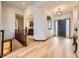 Bright and airy foyer featuring elegant hardwood floors and archways to other rooms at 10050 Eagle Valley Way, Highlands Ranch, CO 80129