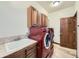 Laundry room with modern washer and dryer, sink, and cabinet storage at 10050 Eagle Valley Way, Highlands Ranch, CO 80129