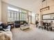 Bright living room with large windows, shutters, and a dining area adjacent to the seating area at 10050 Eagle Valley Way, Highlands Ranch, CO 80129
