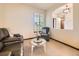 Neutral living area with comfortable seating and natural light from a window at 10050 Eagle Valley Way, Highlands Ranch, CO 80129