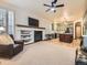 Spacious living room flows into the kitchen featuring a fireplace, TV, and comfortable seating at 10050 Eagle Valley Way, Highlands Ranch, CO 80129