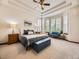 Tranquil main bedroom with tray ceilings, a sitting area by the bay window, and plush carpeting at 10050 Eagle Valley Way, Highlands Ranch, CO 80129