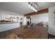 Open concept dining room with a wooden table and a view into the kitchen at 8845 S Brentwood St, Littleton, CO 80128