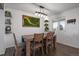 Dining area with a wooden table and a moss wall art piece at 8845 S Brentwood St, Littleton, CO 80128