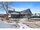 Gray exterior house with solar panels and a partially snow-covered driveway at 8845 S Brentwood St, Littleton, CO 80128