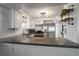 Modern kitchen with white cabinets, stainless steel appliances, and granite countertops at 8845 S Brentwood St, Littleton, CO 80128