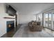 Spacious living room featuring a fireplace and sliding glass doors to deck at 8845 S Brentwood St, Littleton, CO 80128