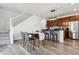 Open concept kitchen and dining area with modern island at 21835 E Radcliff Cir, Aurora, CO 80015