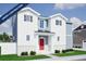 Charming two-story home featuring a bright red front door, white siding, and an inviting front porch at 22394 E 39Th Ave, Aurora, CO 80019