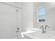 Bright bathroom with a white subway tile shower and a modern vanity with white countertop at 10860 Lyric St, Lone Tree, CO 80134