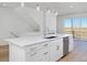 Bright white kitchen boasts stainless steel appliances, ample cabinet space, and an island with stone countertops at 10860 Lyric St, Lone Tree, CO 80134