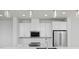This kitchen features white cabinets, stone countertops, stainless steel appliances, and recessed lighting at 10860 Lyric St, Lone Tree, CO 80134