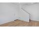 Bright room with hardwood floors, a white door, and a staircase with silver railing at 10860 Lyric St, Lone Tree, CO 80134