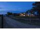 House exterior view at dusk with driveway and wooden fence at 12626 N 1St St, Parker, CO 80134