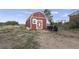 Red barn-style shed with white trim at 12626 N 1St St, Parker, CO 80134
