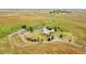 Drone photo illustrating the property's expansive acreage, including house, pond, and outbuildings at 11881 County Road 37, Fort Lupton, CO 80621