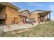 Backyard patio featuring a hot tub, outdoor seating, and well-manicured landscaping at 11881 County Road 37, Fort Lupton, CO 80621
