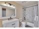 Classic bathroom with marble tile, a shower-tub combo, sleek vanity, and matte black fixtures at 11881 County Road 37, Fort Lupton, CO 80621