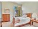 Cozy bedroom with wood furnishings, a window view, and quaint decor at 11881 County Road 37, Fort Lupton, CO 80621