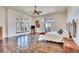 Spacious bedroom features hardwood floors, a large window, and decorative artwork at 11881 County Road 37, Fort Lupton, CO 80621