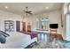Spacious bedroom with hardwood floors, a ceiling fan, and natural light from a large window at 11881 County Road 37, Fort Lupton, CO 80621