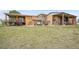 A sprawling home with a covered patio, hot tub, and a large grassy lawn at 11881 County Road 37, Fort Lupton, CO 80621