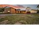 Charming home exterior with unique architectural details and beautiful landscaping at 11881 County Road 37, Fort Lupton, CO 80621