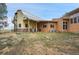 Unique home with barn-style architecture, stone accents, and a metal roof under a blue sky at 11881 County Road 37, Fort Lupton, CO 80621