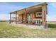 Beautiful home with a large covered patio, outdoor fireplace, and well-maintained lawn at 11881 County Road 37, Fort Lupton, CO 80621