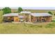 Expansive home exterior featuring a hot tub, patio, and well-manicured lawn, perfect for outdoor living at 11881 County Road 37, Fort Lupton, CO 80621