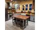 Charming kitchen with an island, gray cabinetry, brick backsplash, butcher block countertops, and stainless steel appliances at 11881 County Road 37, Fort Lupton, CO 80621