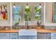 Bright kitchen sink area with stainless steel appliances, butcher block countertops and a large farmhouse-style sink at 11881 County Road 37, Fort Lupton, CO 80621