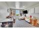 Bright living room with guitars on the wall, comfortable seating, and an arcade game at 11881 County Road 37, Fort Lupton, CO 80621