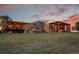 Stunning rear exterior with spacious deck, hot tub, and lush green lawn at 11881 County Road 37, Fort Lupton, CO 80621