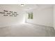 Finished basement featuring neutral carpeting, a window with view well, and decorative shelving at 12547 Lake View St, Longmont, CO 80504
