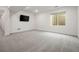 Spacious finished basement with plush carpeting, a window, and pre-wiring for a wall-mounted television at 12547 Lake View St, Longmont, CO 80504