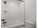 Bathroom featuring a bathtub with white tile surround and modern fixtures at 12547 Lake View St, Longmont, CO 80504