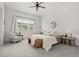 Bright bedroom featuring a ceiling fan, large window, and carpeted floor at 12547 Lake View St, Longmont, CO 80504