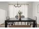 Dining room with modern chandelier and curtains creating a comfortable dining space at 12547 Lake View St, Longmont, CO 80504